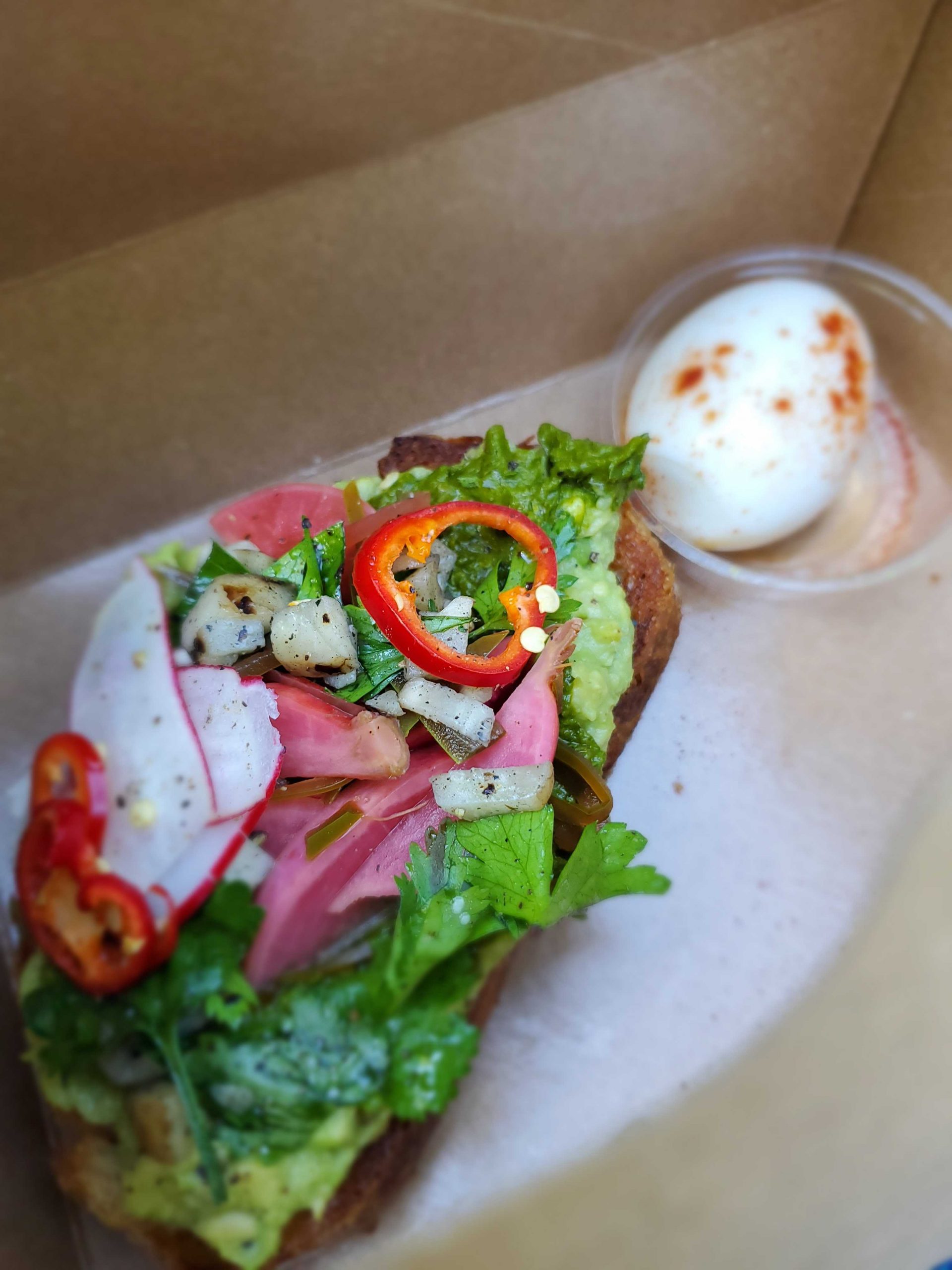 Avocado toast and hardboiled egg in one of the Box of Good meal boxes